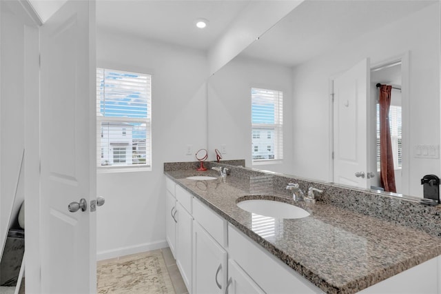 bathroom featuring tile patterned flooring, plenty of natural light, and vanity