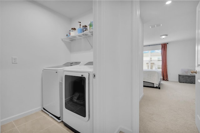 washroom with light colored carpet and washing machine and dryer