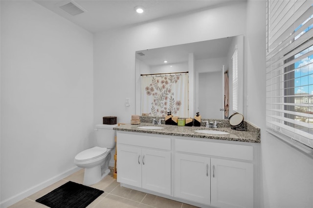 bathroom featuring toilet, vanity, tile patterned floors, and curtained shower