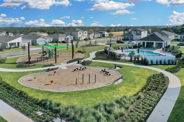 surrounding community with a playground, a pool, and a lawn