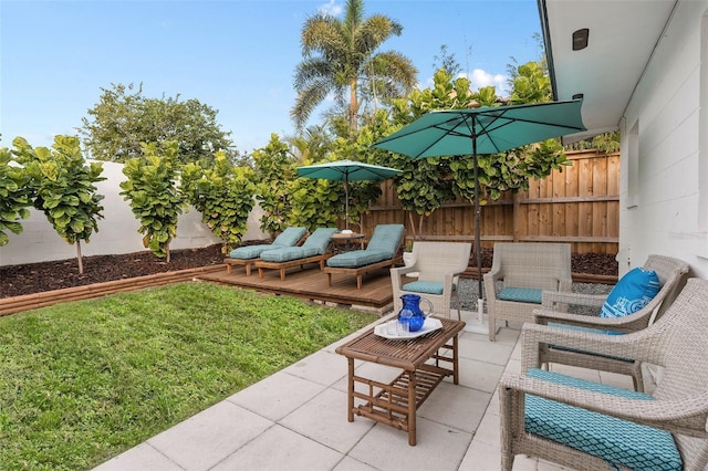 view of patio featuring a fenced backyard, a deck, and outdoor lounge area