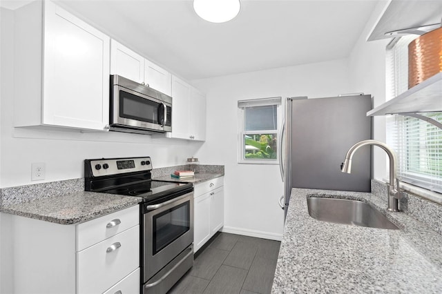 kitchen featuring a healthy amount of sunlight, white cabinetry, appliances with stainless steel finishes, and a sink