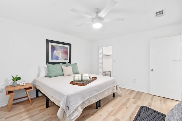 bedroom featuring visible vents, light wood-style flooring, and baseboards