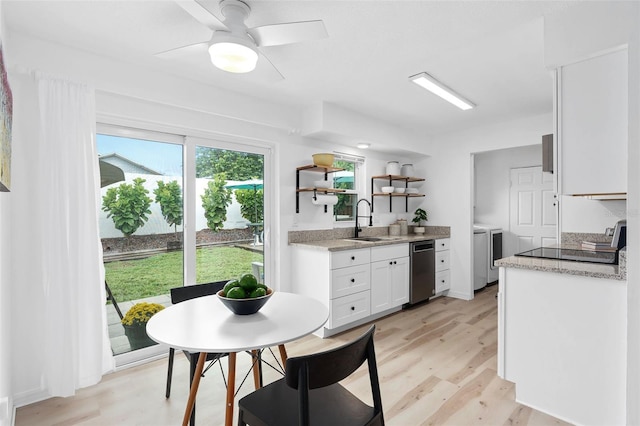 kitchen featuring white cabinets, separate washer and dryer, light wood-style floors, open shelves, and a sink