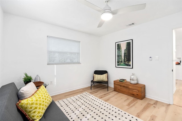 sitting room featuring baseboards, visible vents, ceiling fan, and wood finished floors