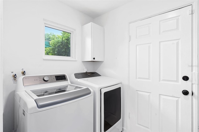 laundry area featuring cabinet space and separate washer and dryer