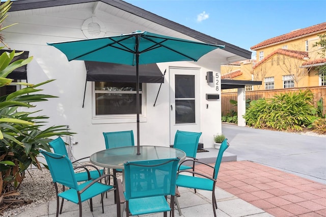 view of patio / terrace with outdoor dining space and fence