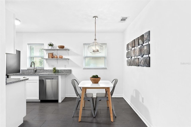 kitchen with open shelves, visible vents, white cabinets, dishwasher, and baseboards