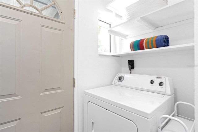 washroom featuring laundry area and washer / dryer