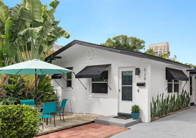 exterior space featuring a patio area and stucco siding