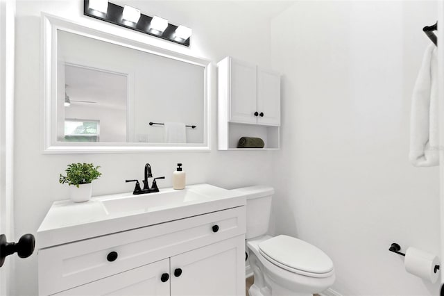 half bath featuring toilet and vanity