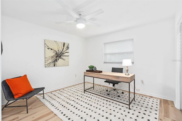 office with baseboards, light wood-style floors, and ceiling fan