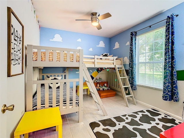 bedroom with ceiling fan, multiple windows, and hardwood / wood-style floors