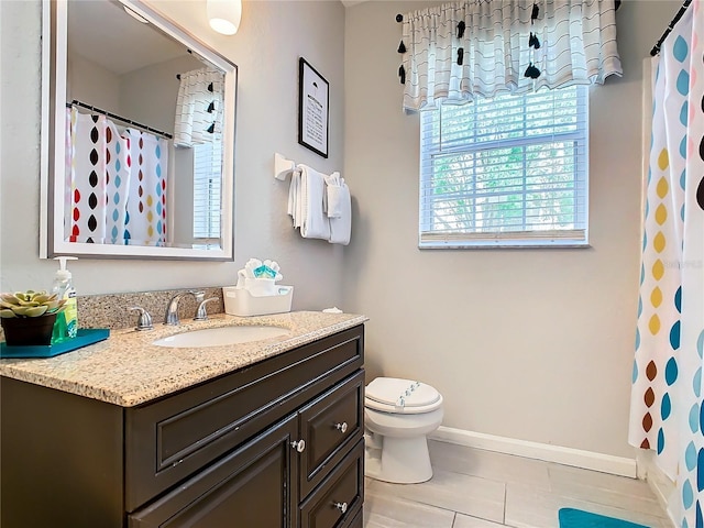 bathroom featuring curtained shower, toilet, vanity, and tile patterned flooring