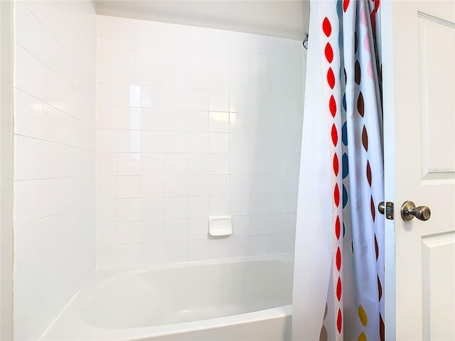 bathroom with shower / tub combo with curtain