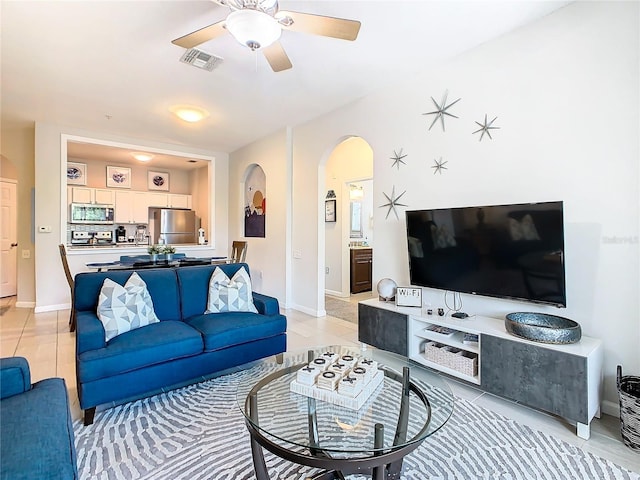 tiled living room with ceiling fan