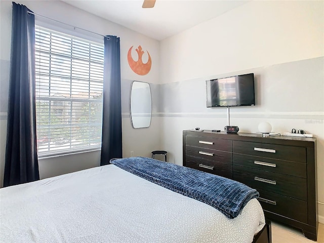 bedroom with ceiling fan and multiple windows