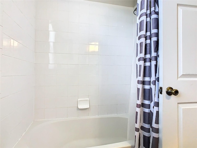 bathroom with shower / bath combo with shower curtain