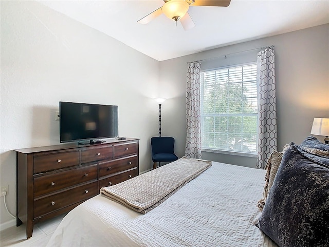 bedroom with ceiling fan and multiple windows