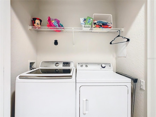 clothes washing area with washer and dryer