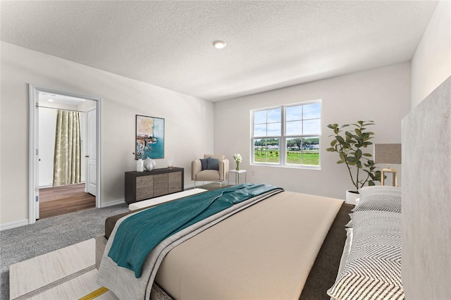 bedroom with a textured ceiling and carpet