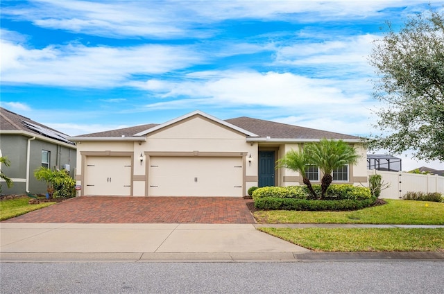 ranch-style house featuring a garage and a front lawn