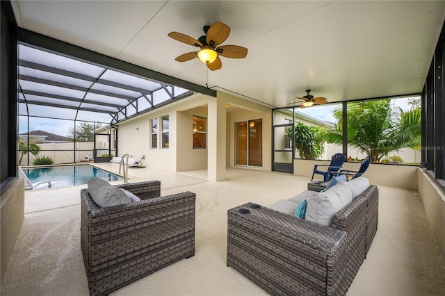 view of patio with a fenced in pool, outdoor lounge area, ceiling fan, and glass enclosure