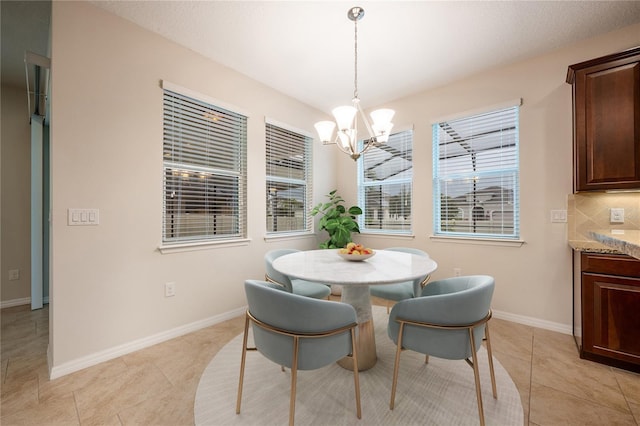 tiled dining room with an inviting chandelier