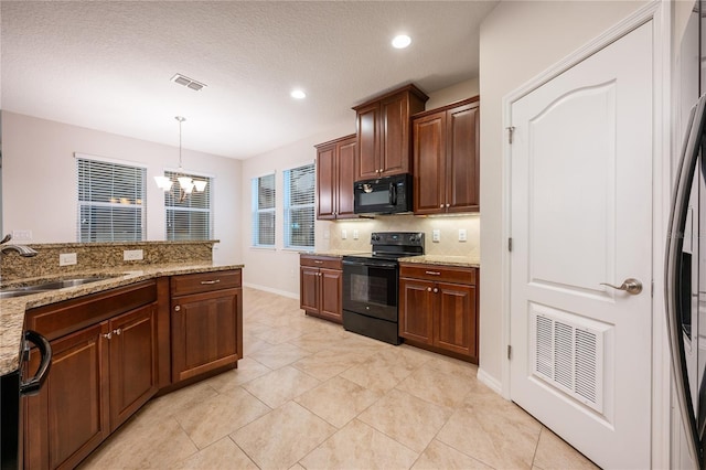 kitchen featuring sink, light stone counters, decorative light fixtures, a chandelier, and black appliances