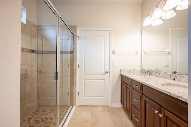 bathroom with tile patterned flooring, vanity, and a shower with shower door