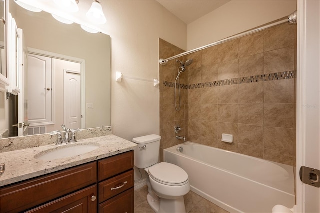 full bathroom with tiled shower / bath combo, vanity, tile patterned flooring, and toilet