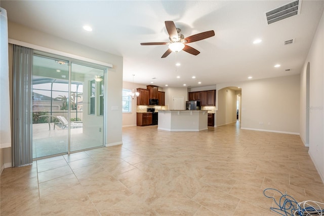 unfurnished living room featuring ceiling fan