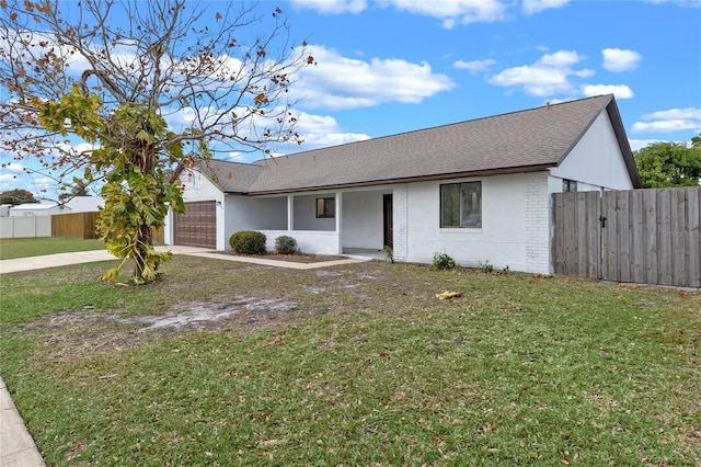 ranch-style home with a front lawn and a garage