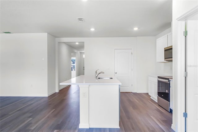 kitchen with white cabinetry, an island with sink, appliances with stainless steel finishes, dark wood-type flooring, and sink