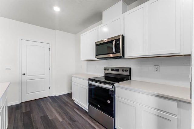 kitchen featuring dark hardwood / wood-style floors, stainless steel appliances, and white cabinets