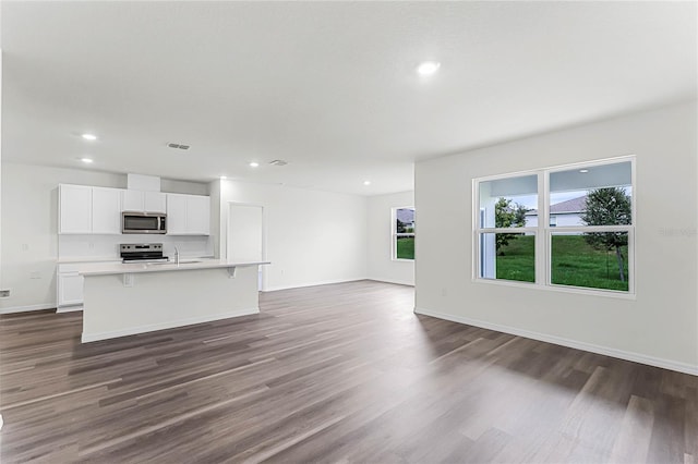 unfurnished living room with dark hardwood / wood-style flooring