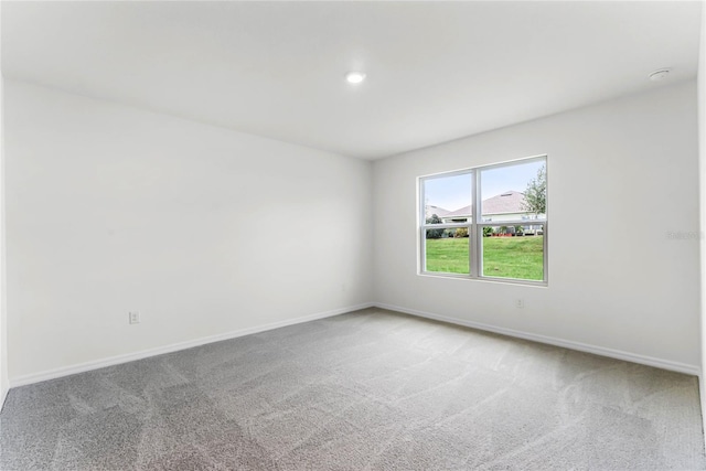 unfurnished room featuring carpet