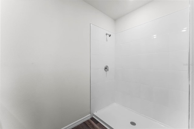 bathroom featuring walk in shower and wood-type flooring