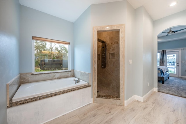 bathroom with ceiling fan and separate shower and tub