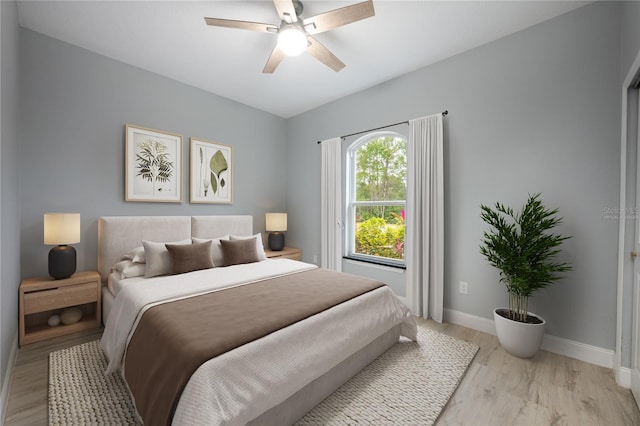 bedroom with light hardwood / wood-style flooring and ceiling fan