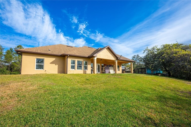 rear view of property featuring a yard