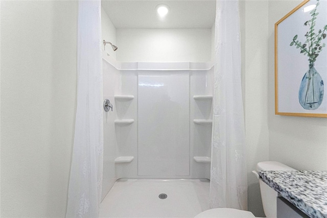 bathroom with toilet and curtained shower