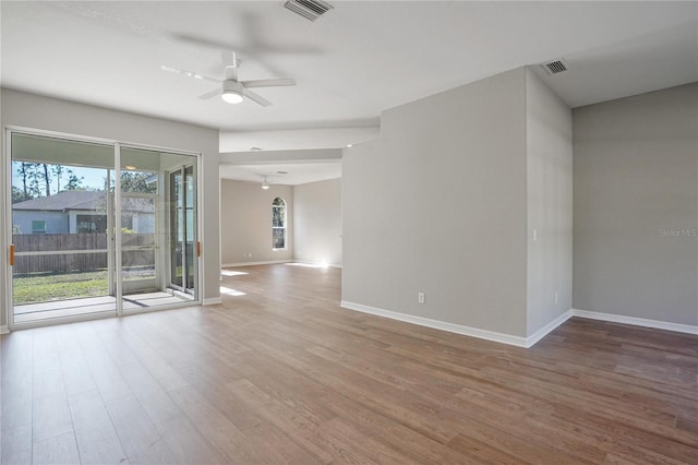 unfurnished room featuring hardwood / wood-style flooring, ceiling fan, and plenty of natural light