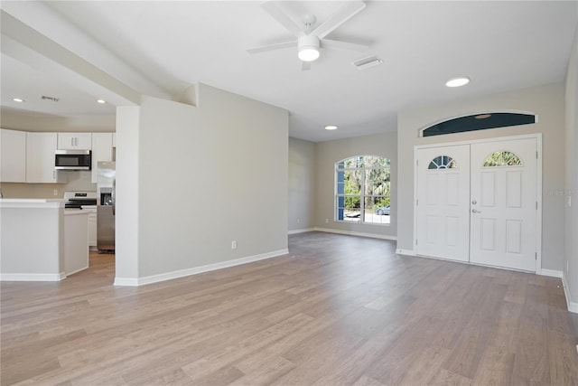 entryway with ceiling fan and light hardwood / wood-style flooring