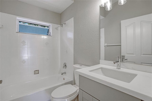 full bathroom with tiled shower / bath, vanity, and toilet