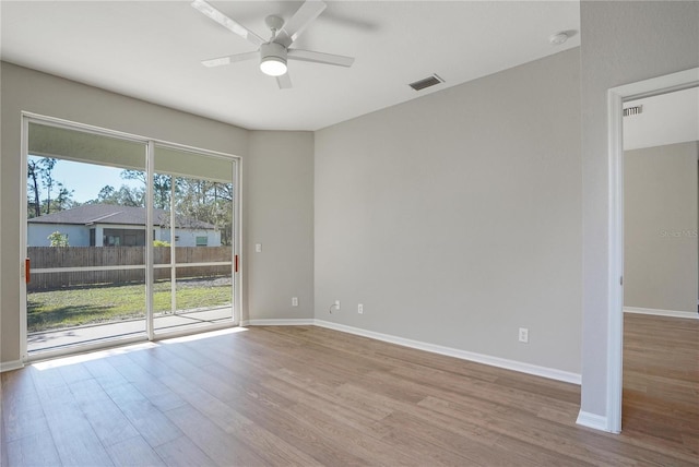 empty room featuring ceiling fan and light wood-type flooring