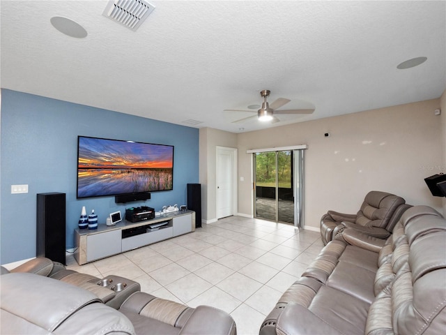 living room featuring a textured ceiling, ceiling fan, and light tile patterned floors