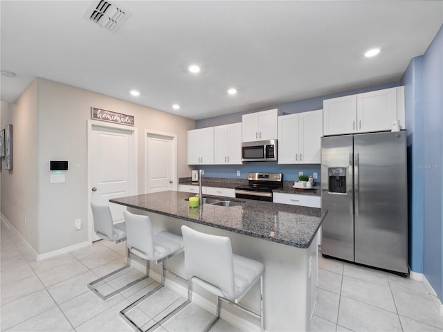 kitchen featuring a center island with sink, stainless steel appliances, white cabinets, and sink