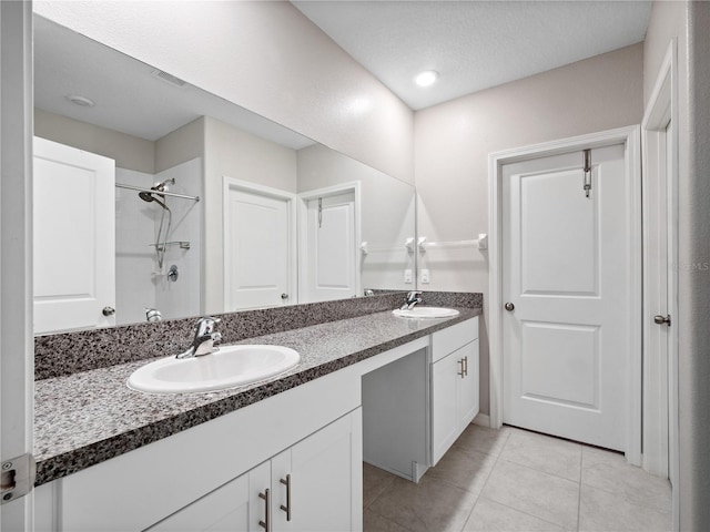 bathroom with vanity, tile patterned floors, and walk in shower