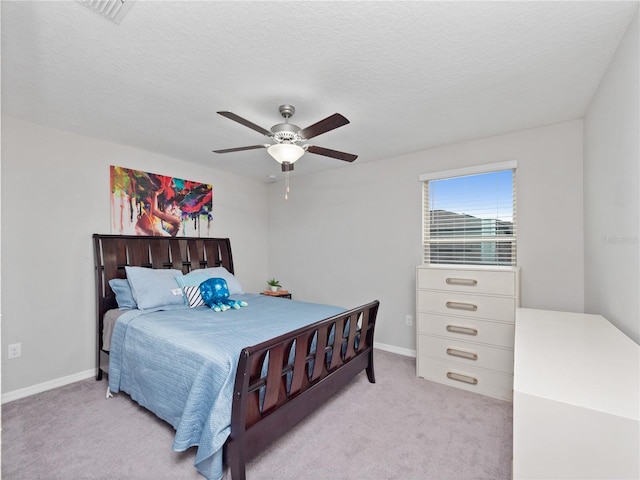 carpeted bedroom with a textured ceiling and ceiling fan